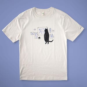 Cat gallery t-shirt | Hand screen printed on beige organic cotton tee with black and blue illustration of a cat judging his own art image 5