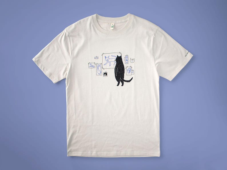 Cat gallery t-shirt | Hand screen printed on beige organic cotton tee with black and blue illustration of a cat judging his own art image 5