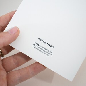 May include: The Printed Cat business card with white background and black text. Instagram: @theprintedcat, shop: theprintedcat.etsy.com, www.theprintedcat.com