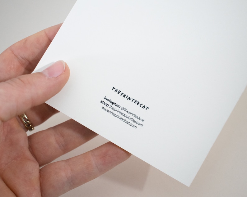 May include: The Printed Cat business card with white background and black text. Instagram: @theprintedcat, shop: theprintedcat.etsy.com, www.theprintedcat.com