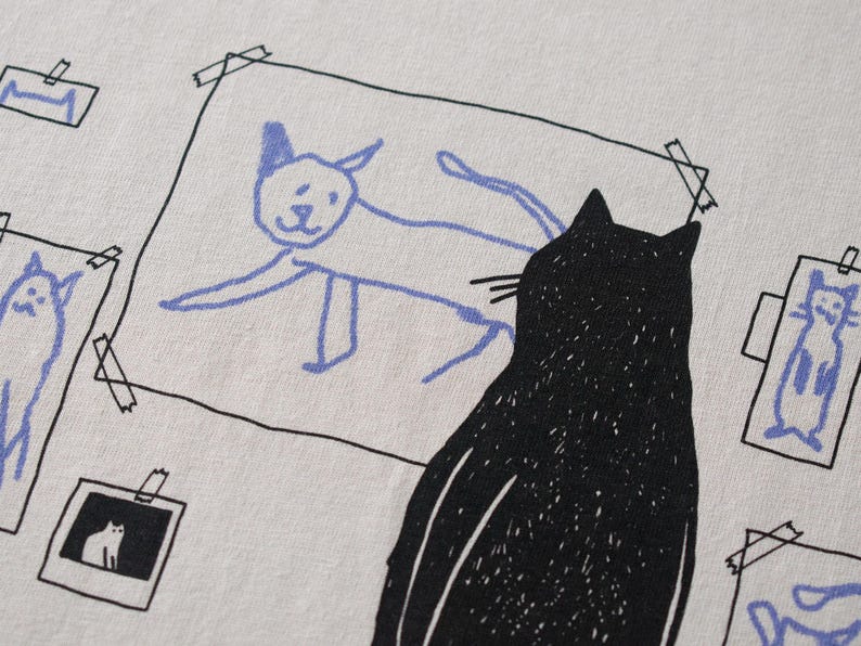Cat gallery t-shirt | Hand screen printed on beige organic cotton tee with black and blue illustration of a cat judging his own art image 7