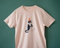 Orange Cat t-shirt | Hand screen printed illustration of a cat balancing oranges on misty pink organic cotton tee with navy and orange product logo
