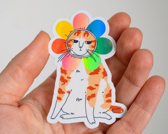 Chagrijnige bloemkat | Holografische vinylsticker van een prikkelbare oranje gestreepte kat, gekleed in een regenboogkleurig bloemblaadjeskostuum om zijn hoofd