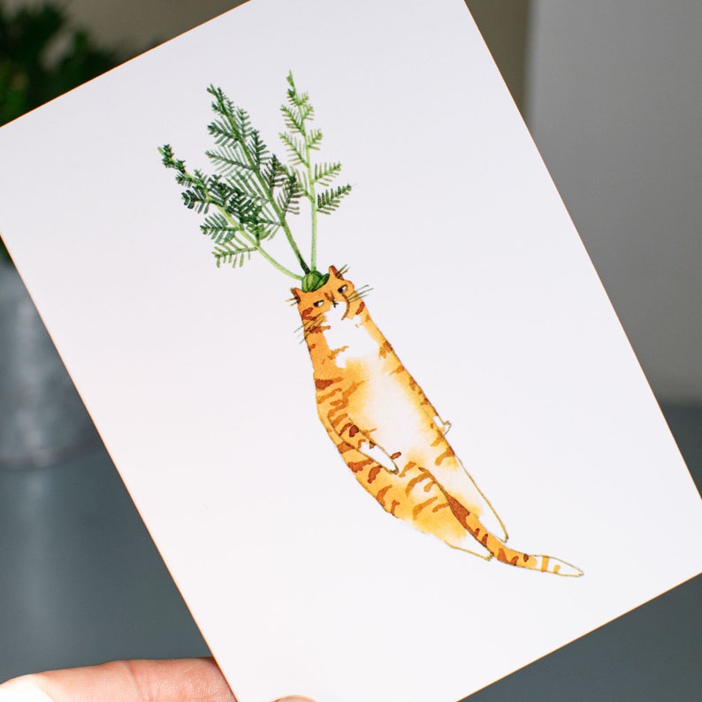May include: A watercolor painting of an orange cat with green leafy stems growing out of its head, resembling a carrot.