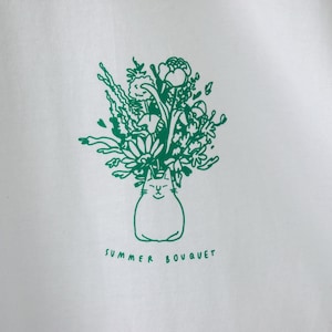 Zomerboeket T-shirt Handgezeefdrukte illustratie van 7 katten met bloemenkronen en andere planten in het groen op een wit T-shirt van biologisch katoen afbeelding 3