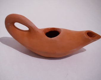 red terracotta oil lamp