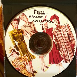 May include: A CD with a white background featuring five women wearing vintage clothing and hats. The text "Full Haslam Collection" is written in black ink on the CD.