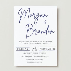 May include: A white wedding invitation with navy blue script. The text reads "Morgan & Brandon" above the invitation details, including the date, time, and location: New Orleans, Louisiana.