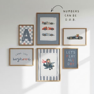 May include: A gallery wall set of six framed prints featuring illustrations of vintage race cars, a bear in an airplane, and typography. Text includes "ARCHIE", "LONG LIVE boyhood", "LET'S PLAY ALL DAY", and "NUMBERS CAN BE D.O.B.".