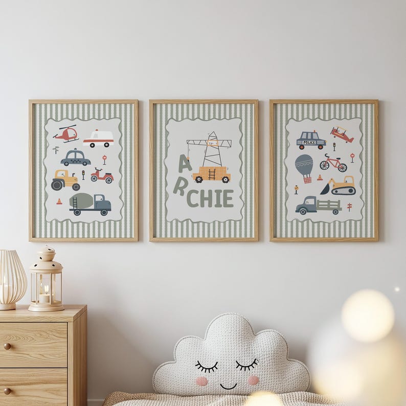 May include: Three framed wall art prints featuring light green and white vertical stripes. The prints display illustrations of various vehicles including a helicopter, ambulance, tractor, crane, police car, bicycle, hot air balloon, and truck, with the name ARCHIE.