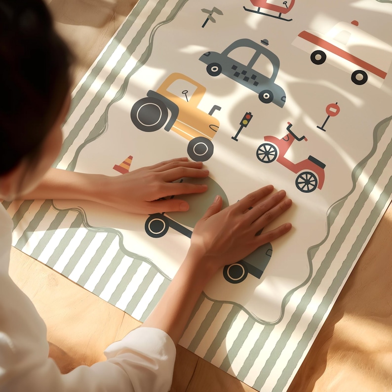 May include: A rectangular play mat featuring a cream-colored center with illustrations of a yellow tractor, a blue taxi, a red scooter, a helicopter, and traffic signs. The mat has a sage green and white striped border with a wavy edge design.