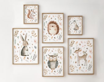 May include: A set of six framed watercolor art prints featuring woodland animals. The prints include a squirrel, hedgehog, fox, rabbit, owl, and deer, all surrounded by leaves and botanical elements. The frames are gold.