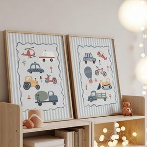 May include: Two framed wall art prints featuring illustrations of various vehicles including a helicopter, ambulance, taxi, tractor, cement mixer, police car, airplane, bicycle, hot air balloon, and excavator, set against a light blue striped background.