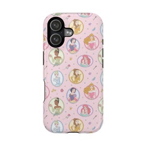 May include: A pink phone case featuring a repeating pattern of cartoon princess portraits in oval frames. The case has a black camera cutout and a glossy finish. Additional design elements include crowns, roses, and seashells.