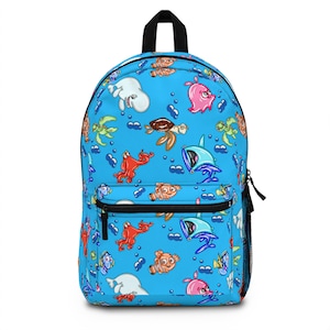 May include: A blue backpack with a black handle and zipper. The backpack is covered in a pattern of cartoon sea creatures, including fish, turtles, and octopuses. The backpack has a mesh side pocket.