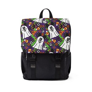 May include: Black backpack with a Halloween-themed pattern featuring ghosts, Mickey Mouse, candy corn, and the word "Spook". The top flap has a purple background with green spiderwebs. The backpack has black straps and buckles.