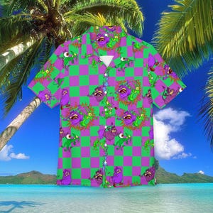 May include: Short-sleeved button-down shirt with a vibrant pattern. The shirt features a checkerboard design in green and purple, adorned with cartoon monster illustrations. The shirt is a tropical style, perfect for a holiday.