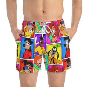 May include: Bright swim shorts with a colourful collage of cartoon characters in different poses. The shorts have a drawstring closure and are made of a lightweight material. The design includes characters in red, yellow, blue, and green squares.