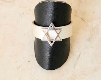 May include: A silver ring with a Star of David design.