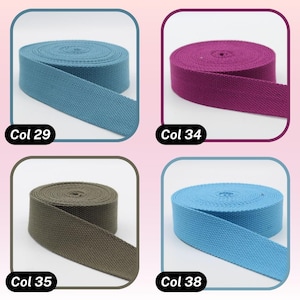 May include: Four spools of colorful canvas webbing are displayed, each in a different shade. The colors include teal, magenta, olive green, and light blue. Each spool is labeled with a color code, such as "Col 29" and "Col 34".