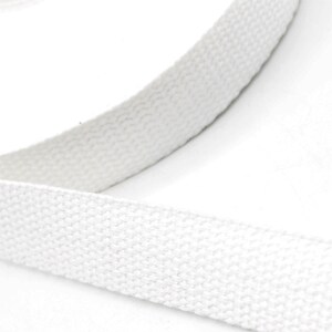 May include: Close-up of a white, woven fabric strap. The strap is thick and appears to be made of a durable material. The texture of the fabric is visible, with a slightly raised, ribbed pattern. The strap is likely used for crafting or sewing projects.