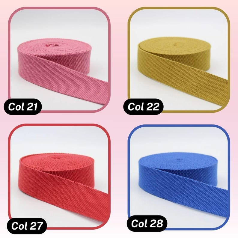 May include: Four spools of colorful webbing ribbon are displayed. The colors include pink (Col 21), gold (Col 22), red (Col 27), and blue (Col 28). Each spool is neatly rolled, with a portion of the ribbon unrolled, showcasing the material's texture.