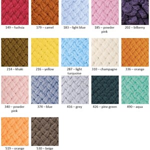 May include: A color chart of yarn samples in various colors, including fuchsia, camel, light blue, powder pink, bilberry, khaki, yellow, light turquoise, champagne, orange, powder pink, blue, grey, pine green, aqua, orange, and beige.