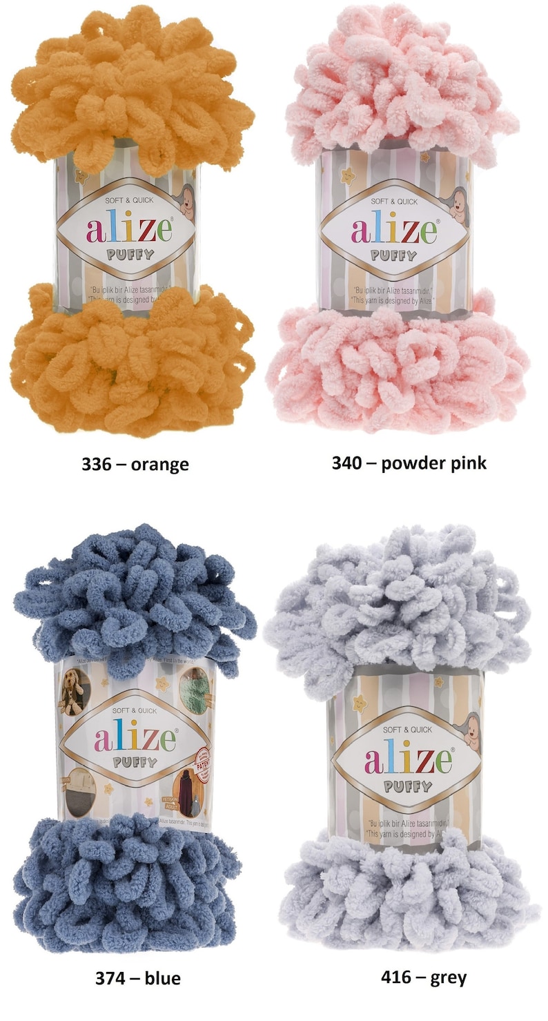 May include: Four skeins of yarn in different colors: orange, powder pink, blue, and grey. The yarn is fluffy and textured. The label on each skein reads "alize puffy" and includes the text "Soft & Quick".