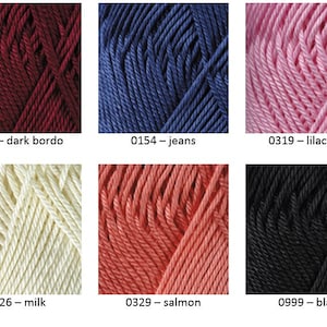 May include: Six skeins of yarn in different colors: dark burgundy, blue, pink, cream, coral, and black. Each skein is labeled with a number and color name.