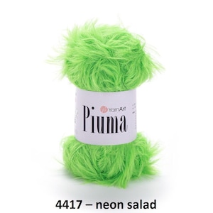 Puede incluir: Tres ovillos de hilo en diferentes colores: verde esmeralda, verde neón y amarillo. Cada ovillo está etiquetado con "Piuma" y tiene una textura esponjosa.