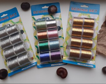 May include: Three packages of sewing thread, each containing six spools of thread. The spools are silver, gold, and a variety of colors. Each package has the text "Sewing Set" and "Made in China".