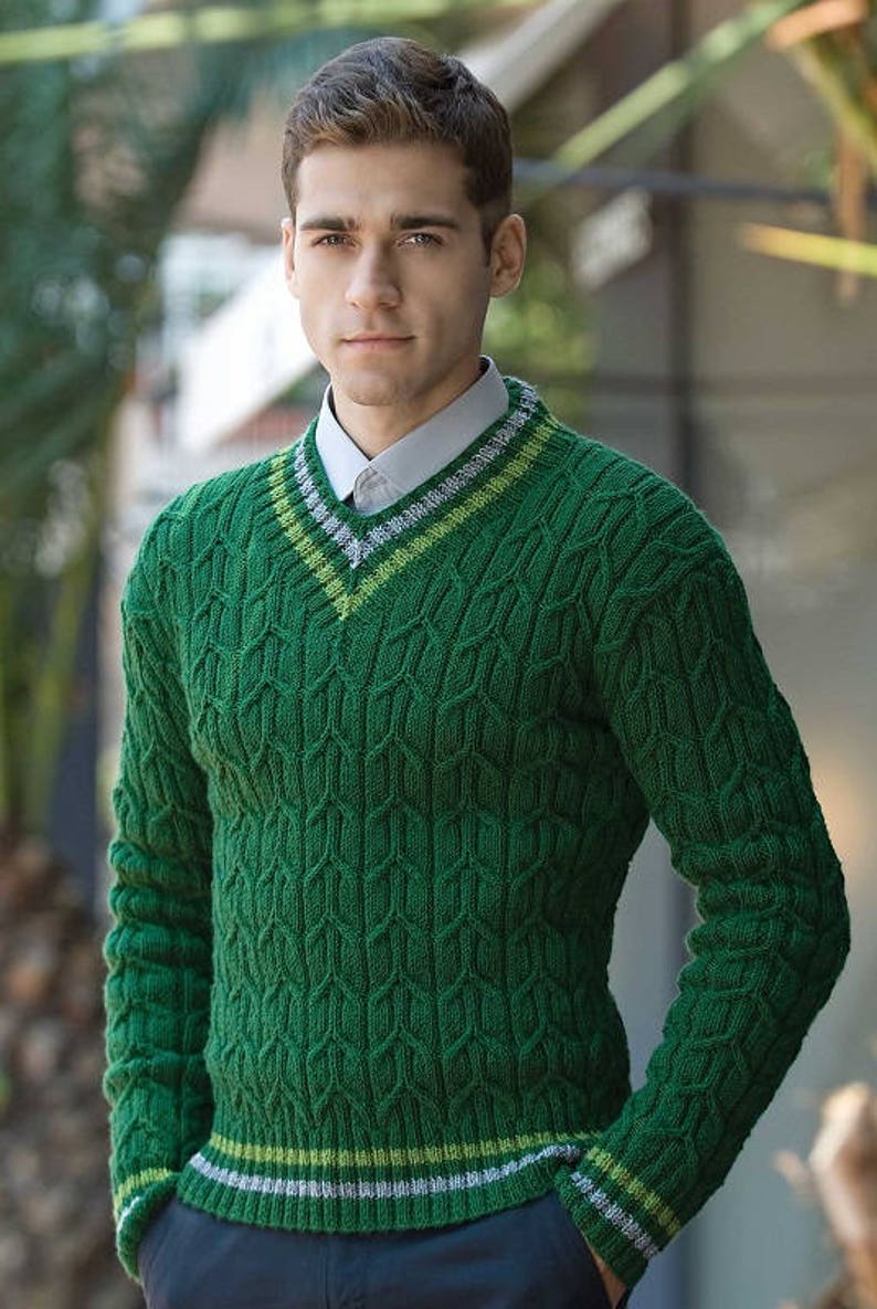 May include: A green cable knit sweater with a v-neck and white and green stripes around the neck and bottom hem.