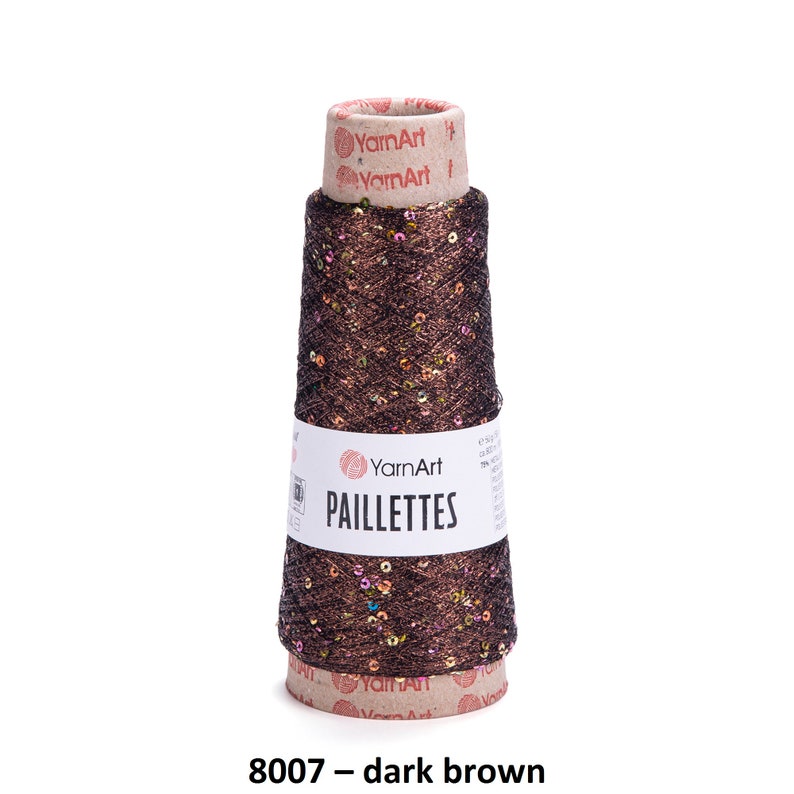 May include: A spool of dark brown yarn with iridescent sequins, labeled "YarnArt Paillettes 8007 - dark brown".
