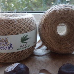 May include: Two spools of natural brown twine, one with a label that reads "Джут Конопля 100%" and "Ярославль".