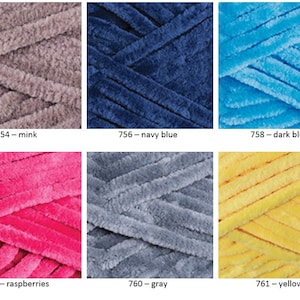May include: Six skeins of yarn in different colors: mink, navy blue, dark blue, raspberries, gray, and yellow. Each skein is made of a soft, fuzzy material.