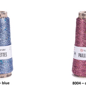 May include: Two spools of yarn with sequins, one blue and one pink. The yarn is labeled "YarnArt Paillettes".