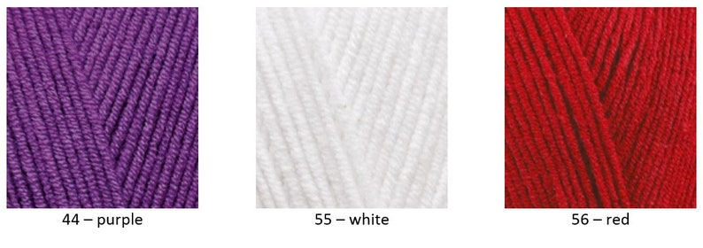 May include: Three balls of yarn in different colours: purple, white and red. The yarn is labelled with numbers and colour names: 44 - purple, 55 - white, 56 - red.