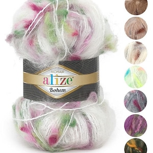May include: A skein of Alize Bohem mohair yarn in a white, pink, and green colorway. The yarn is soft and fluffy, and it is perfect for knitting or crocheting warm winter accessories. The yarn is shown in a close-up view, and the label is visible in the image. The label reads "Alize Bohem Mohair".