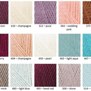 May include: A color chart of yarn samples in various shades of red, pink, blue, brown, gray, and white. The yarn samples are arranged in a grid of 3 rows and 5 columns. Each sample is labeled with a number and a color name.