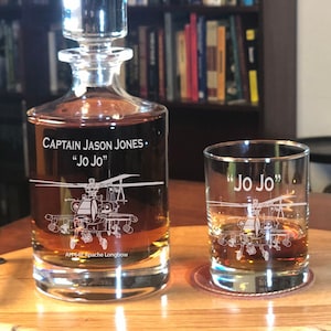 May include: A personalized glass decanter and tumbler set with an etched design of an AH-64 Apache Longbow helicopter. The decanter is engraved with the text "CAPTAIN JASON JONES. "Jo Jo"" and the tumbler is engraved with the text "Jo Jo".