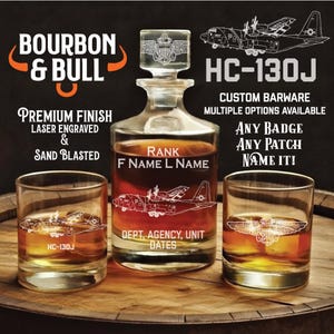 May include: A custom barware set featuring a decanter and two glasses, all etched with an aircraft design and the text "HC-130J." The decanter has a stopper with a crest design. The set includes the text "Bourbon & Bull" and "Premium Finish Laser Engraved & Sand Blasted."