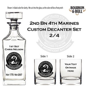 May include: A custom decanter set with two glasses. The decanter is clear glass with a frosted etching of the 2nd Battalion 4th Marines logo. The glasses are also clear glass with the same logo on one and a space for personalization on the other. The set is a gift for a 1st Sergeant named Chris Nelson.