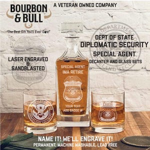 May include: A glass decanter and two glasses with laser engraved designs. The decanter and glasses feature a Department of State Diplomatic Security Special Agent badge with the text "Special Agent IMA Retire" on the decanter. The glasses have the text "Department of Homeland Security" and "DHS US Police" on them. The text "Name it! We'll engrave it! Permanent, machine washable, lead free" is also included.