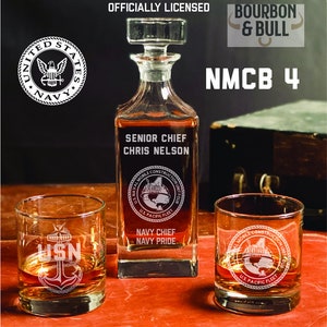 May include: A set of three etched glass decanters and glasses with a Navy theme. The decanter is engraved with "Senior Chief Chris Nelson", "U.S. Naval Mobile Construction Unit Four", "U.S. Pacific Fleet", "Navy Chief Navy Pride". The glasses are engraved with "USN" and an anchor, and "U.S. Naval Mobile Construction Unit Four", "U.S. Pacific Fleet".
