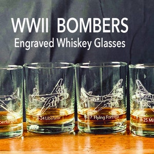 May include: Four engraved whiskey glasses with different WWII bomber silhouettes. The glasses are labeled B-29 Superfortress, B-24 Liberator, B-17 Flying Fortress, and B-25 Mitchell.