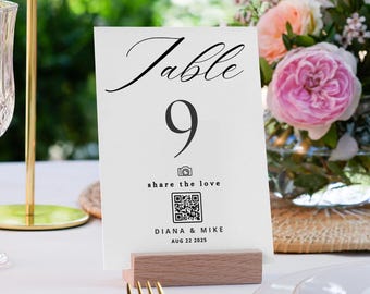 May include: White table number card with black text that reads "Table 9 share the love" with a camera icon and a QR code. Below the QR code is the text "DIANA & MIKE AUG 22 2025".