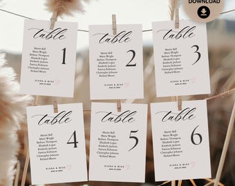 May include: Six white table cards with black calligraphy that says "Table" and a black number from 1 to 6. Each card has a list of names in black text, ending with "DIANA & MIKE" and the date "AUG 22 2023".