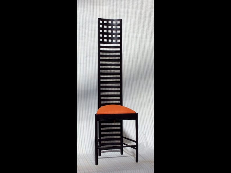 May include: A tall, black wooden chair with a geometric pattern on the back and an orange upholstered seat.
