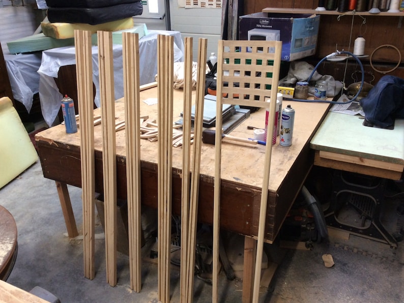 May include: A workshop table with wooden slats and a lattice panel. The slats are stacked and ready for assembly. The lattice panel is made of thin strips of wood and has a square grid pattern.