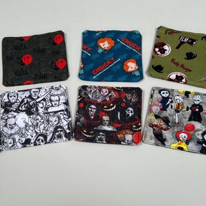 May include: Ten square fabric coasters featuring horror movie characters. The coasters are made of a soft, absorbent fabric and are perfect for protecting your furniture from spills and scratches. The coasters feature a variety of characters, including Pennywise the clown, Freddy Krueger, Jason Voorhees, Chucky, and Dracula. The coasters are a great way to show your love of horror movies and add a touch of spooky fun to your home.